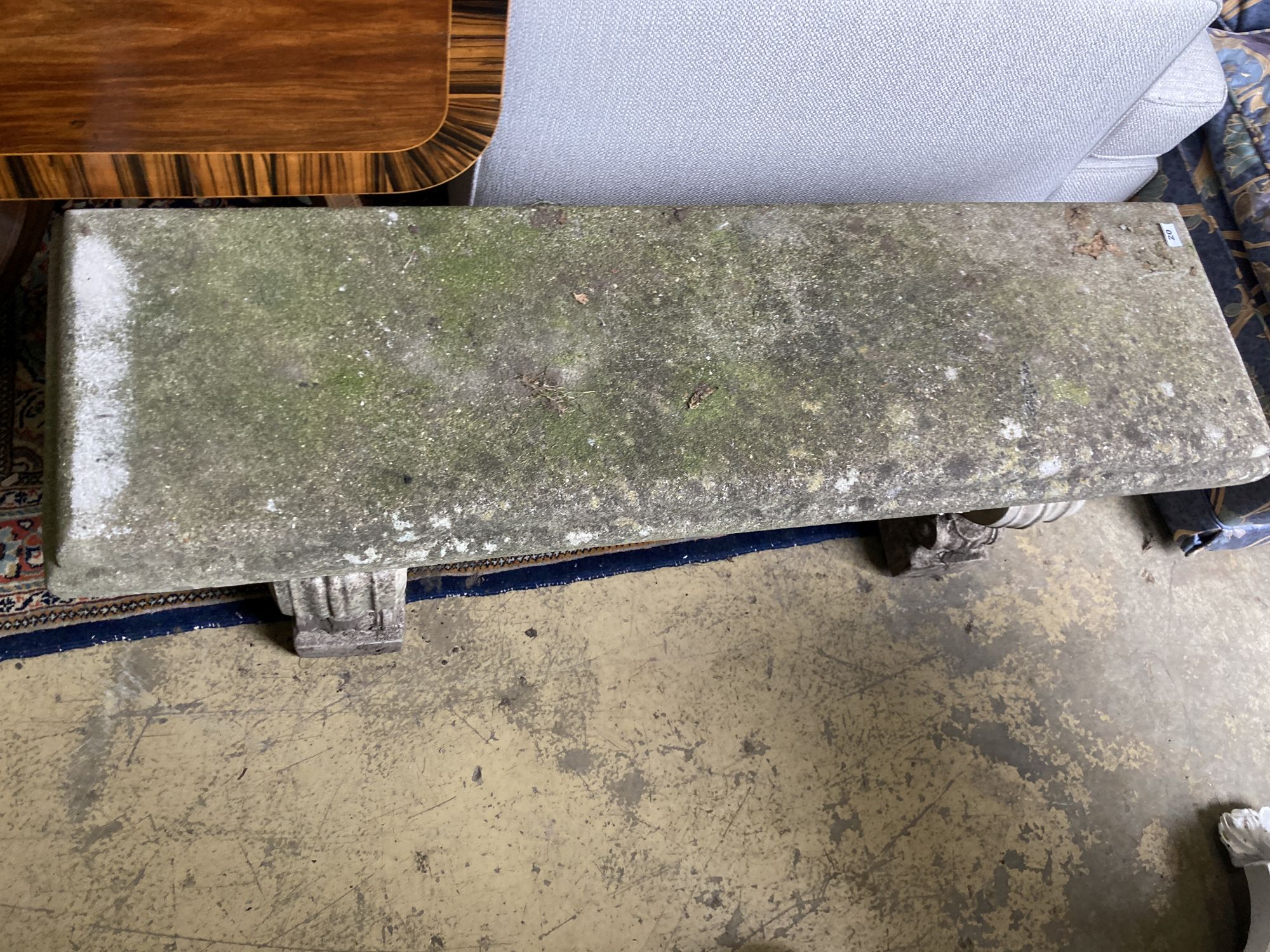 A reconstituted stone garden bench seat, length 126cm, depth 38cm, height 45cm
